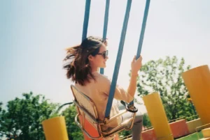 Young woman on a swing ride at an amusement park.